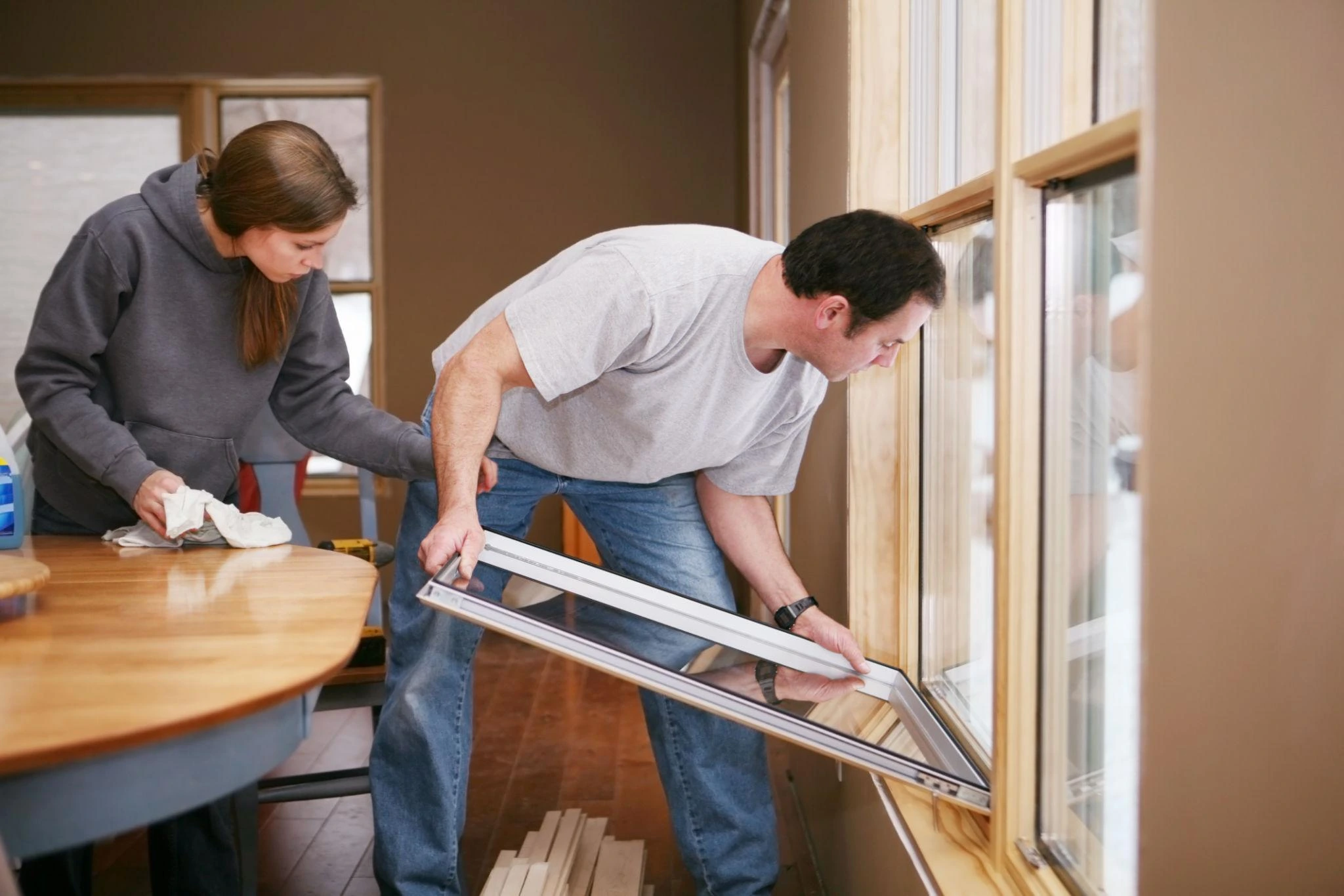 image of household owners performing Double Glazing Repair vs Replacement